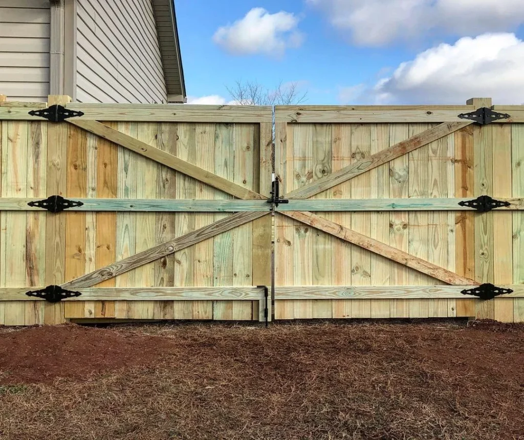 Wood privacy fence with double drive gate by Johnson Decks & Porches